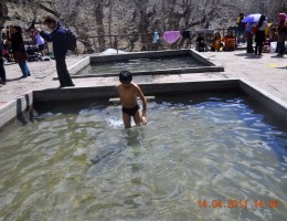 A young boy taking bath at the pond of Muktinath