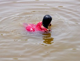 Devotee taking holy dip in the pond